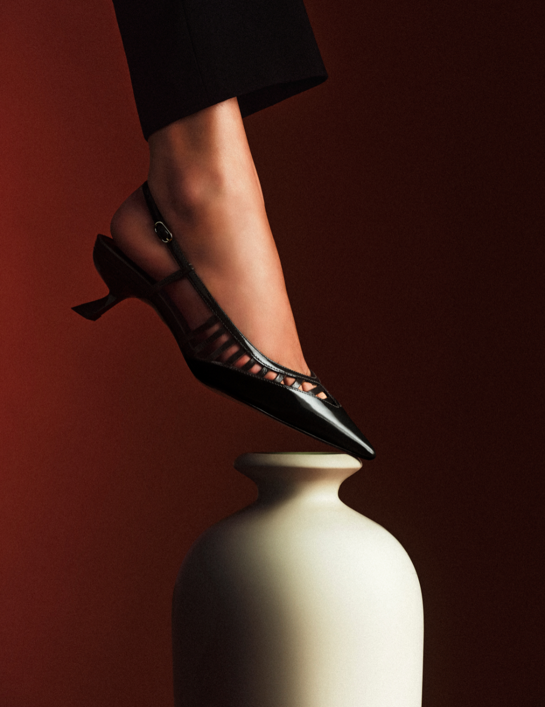 Subtle Tones: Model on chic white couch wearing pointed toe flat Asymmetric Clarita Mary Jane Orange. Discover New Arrivals in Pre-Fall.