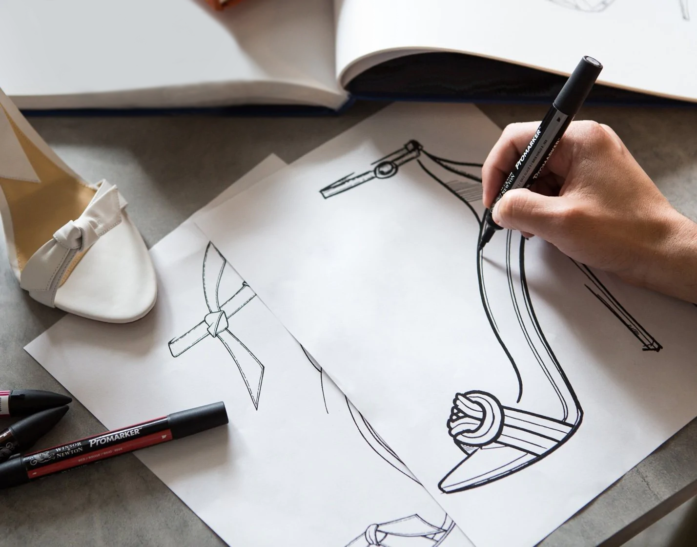 Crafted with Passion: Observe our talented designer bringing the iconic Vicky Sandal to life with each stroke of creativity. From sketch to reality, this masterpiece embodies the dedication and passion that defines our handcrafted luxury.